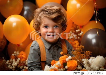 Cute baby sitting on floor with festive balloons in room. Birthday boy 112323917