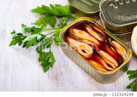 Marinated mussels in oil with lemon and greens Marinated mussels in oil with lemon and greens 112324299