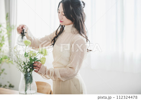 花を生ける若い女性のライフスタイルイメージ 花を生ける若い女性のライフスタイルイメージ 112324478