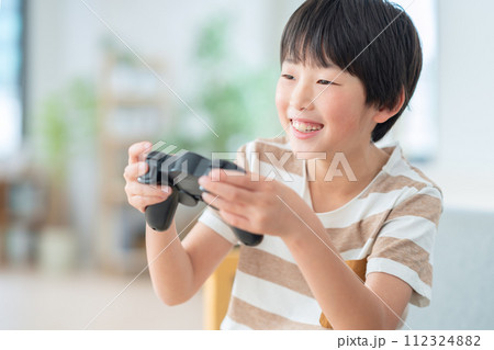 リビングでゲームをする男の子 リビングでゲームをする男の子 112324882