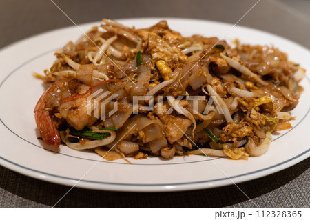 Fried Char Kway Teow is a stir-fried rice noodle dish popular food in Malaysia and Singapore. Fried Char Kway Teow is a stir-fried rice noodle dish popular food in Malaysia and Singapore. 112328365