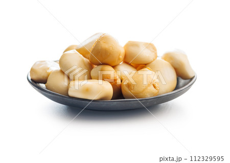 Smoked mini scamorza cheese. Traditional italian cheese on plate  isolated on white background. 112329595