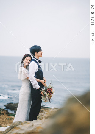 海岸で寄り添う新郎新婦 海岸で寄り添う新郎新婦 112330974