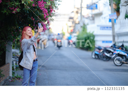 Fashionable young woman with pink hair style, she making selfie. 112331135