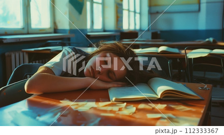 A student is sleeping in the classroom. A student is sleeping in the classroom. 112333367
