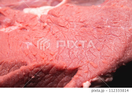 Raw large premium steak. Raw fresh premium beef in shallow depth of field 112333814