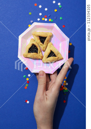 A mask with traditional cookies for the day of Purim. A mask with traditional cookies for the day of Purim. 112334105