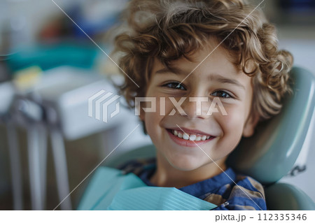 Photo of smiling boy in dental chair, visit to the dentist 112335346
