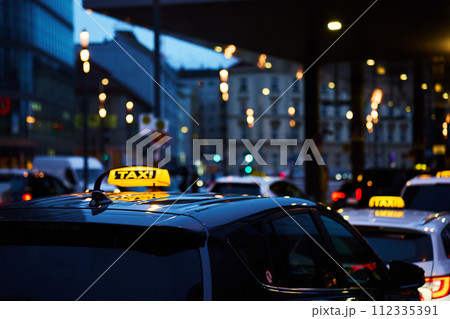 Twilight Taxi Service in City Center During Rush Hour Traffic Twilight Taxi Service in City Center During Rush Hour Traffic 112335391