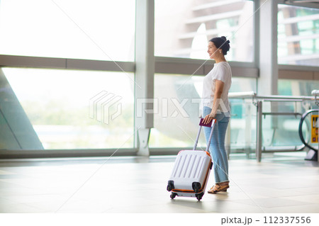 Young Asian woman in airport. Travel by air. Young Asian woman in airport. Travel by air. 112337556