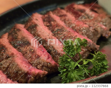 Close up Beef Steak Medium Rare. Grilled Juicy steak medium rare beef with herbs. 112337668