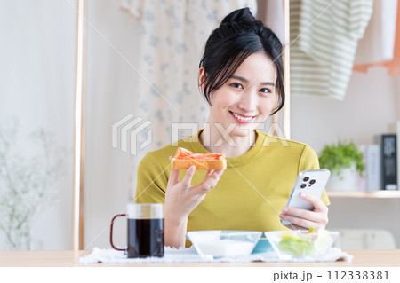 朝食を食べる若い女性 朝食を食べる若い女性 112338381