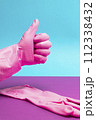Hand in Pink latex glove giving thumbs up sign 112338432