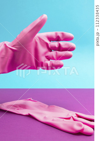Hand in Pink latex glove in position for shaking. Hand shake 112338435