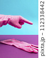 Hand in Pink latex glove pointing index finger 112338442