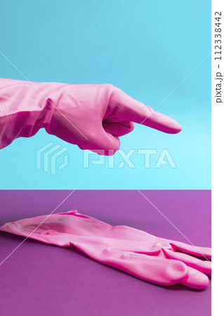 Hand in Pink latex glove pointing index finger 112338442