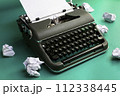 Vintage typewriter and crumpled paper sheets. Writer and blogger concept 112338445