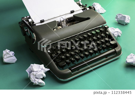Vintage typewriter and crumpled paper sheets. Writer and blogger concept 112338445