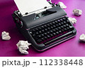 Vintage typewriter and crumpled paper sheets. Writer and blogger concept 112338448