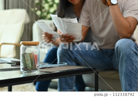 Cropped shot of stressed young couple discussing unpaid debt or money problems at home 112338792