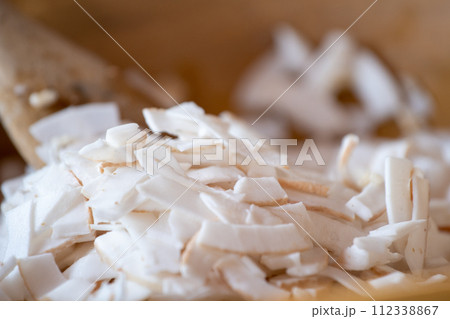 Fresh coconut flakes, closeup Fresh coconut flakes, closeup 112338867