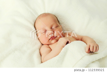 Portrait of infant sweet sleeping lying on white bed at home Portrait of infant sweet sleeping lying on white bed at home 112339321