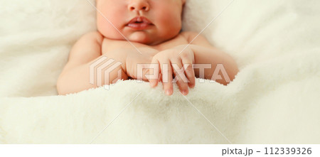 Close up portrait of infant sleeping lying on white bed at home 112339326