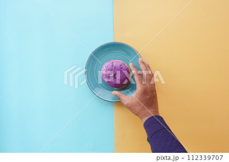 hand holding fresh donuts top view 112339707