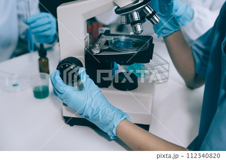 Scientist works with a pipette and a test tube. Scientific laboratory of biotechnology, development of medicine and research in chemistry, biochemistry and experiments. 112340820