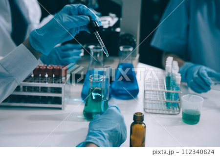 Scientist works with a pipette and a test tube. Scientific laboratory of biotechnology, development of medicine and research in chemistry, biochemistry and experiments. 112340824