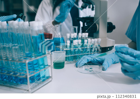 Scientist works with a pipette and a test tube. Scientific laboratory of biotechnology, development of medicine and research in chemistry, biochemistry and experiments. 112340831