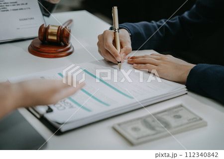 Legal counsel presents to the client a signed contract with legal law. justice and lawyer concept in office. Legal counsel presents to the client a signed contract with legal law. justice and lawyer concept in office. 112340842