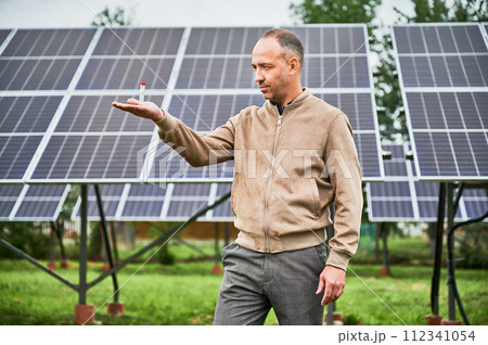 Time working for investor. Confident man waiting for results of his investments. Man invested in green energy and waiting for his income. 112341054