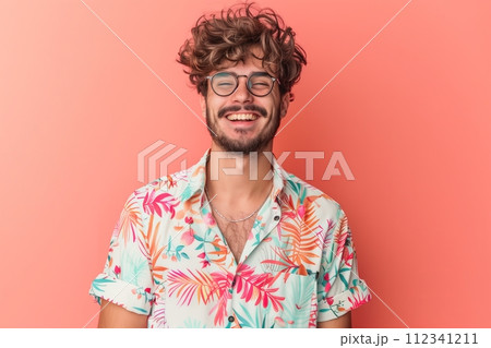 A man with glasses and a floral shirt is smiling 112341211