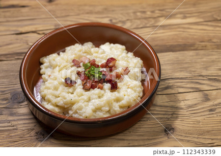 Slovakian halusky served with sheep cheese and roasted bacon 112343339