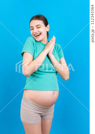 Young beautiful pregnant woman on isolated colored background celebrating surprised and amazed for success with arms raised and open eyes. Winner concept Young beautiful pregnant woman on isolated colored background celebrating surprised and amazed for success with arms raised and open eyes. Winner concept 112343364