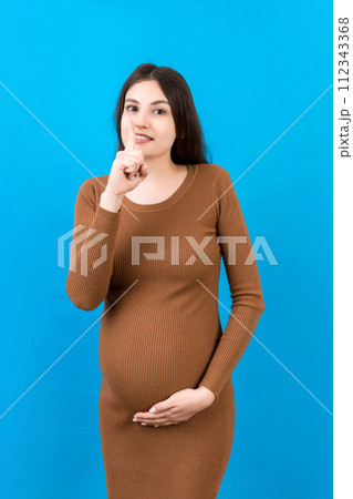 Young beautiful brunette woman pregnant expecting baby over isolated colored background asking to be quiet with finger on lips. Maternity Silence and secret concept Young beautiful brunette woman pregnant expecting baby over isolated colored background asking to be quiet with finger on lips. Maternity Silence and secret concept 112343368