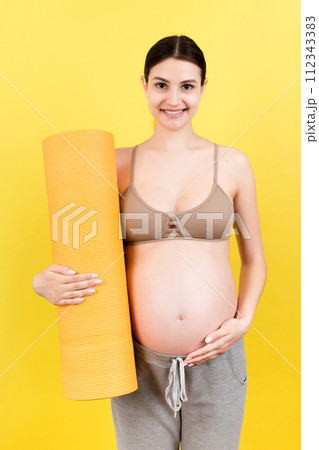 Pregnant Girl Holding Yoga Mat Standing Over Colored Background. Studio Shot, Free Space For Design Pregnant Girl Holding Yoga Mat Standing Over Colored Background. Studio Shot, Free Space For Design 112343383