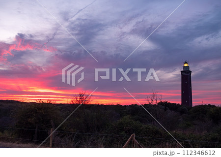 Twilight Guardian: Lighthouse Against Fiery Sky 112346612