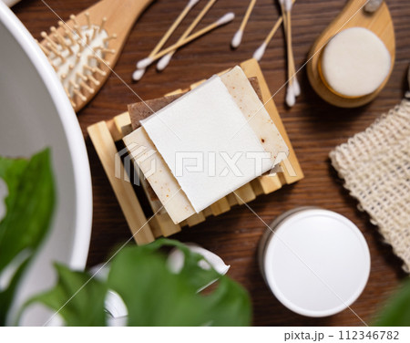 Soap bar with blank label near hygiene products on wood in bathroom top view, mockup Soap bar with blank label near hygiene products on wood in bathroom top view, mockup 112346782
