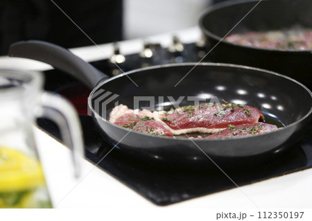 Fry meat in a frying pan.Fry the duck. Preparation of meat dishes. Fry meat in a frying pan.Fry the duck. Preparation of meat dishes. 112350197