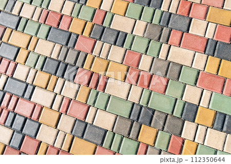 Colorful paving stones in urban park landscaping design as background Colorful paving stones in urban park landscaping design as background 112350644