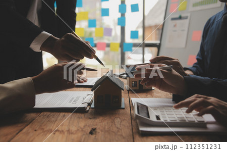 Real estate agent and Sales manager team analysis pricing of rental lease contract of sale purchase agreement, concerning mortgage loan offer for and house insurance. 112351231