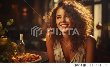 Young Caucasian tanned beautiful elegant woman eating delicious Italian thick pizza in a restaurant 112351286