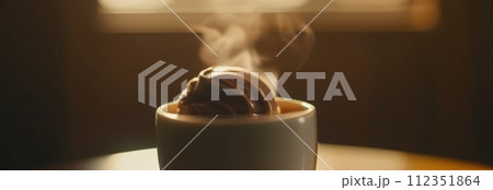 Delicious cup of ice cream sits on table in front of window, basking in natural light. For advertising, banner, relaxation, lifestyle, menu, food, dessert, culinary or cafe themed content. Copy space. 112351864
