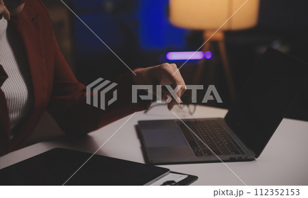 Business woman using calculator for do math finance on wooden desk in office and business working background, tax, accounting, statistics and analytic research concept 112352153