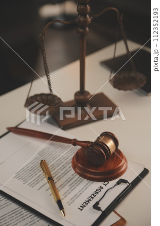 image of judge's hammer, scales lady of justice, law book, laptop computer and contract documents with pen concept of law and justice. image of judge's hammer, scales lady of justice, law book, laptop computer and contract documents with pen concept of law and justice. 112352193