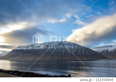 Fjord, mountains and cloudy sky, Iceland 112353044