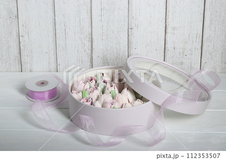 Marshmallows in hatboxes. Marshmallow flowers. Homemade marshmallows. A white hatbox. There is a packing tape next to it. Marshmallows in hatboxes. Marshmallow flowers. Homemade marshmallows. A white hatbox. There is a packing tape next to it. 112353507