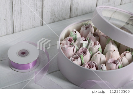 Marshmallows in hatboxes. Marshmallow flowers. Homemade marshmallows. A white hatbox. There is a packing tape next to it. Marshmallows in hatboxes. Marshmallow flowers. Homemade marshmallows. A white hatbox. There is a packing tape next to it. 112353509